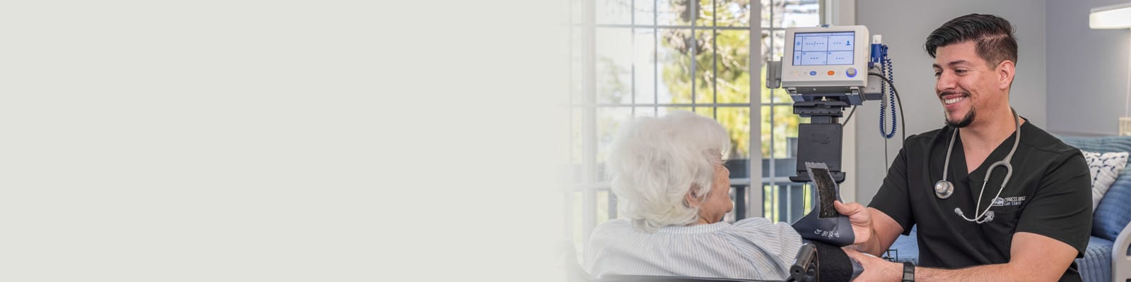 A nurse checking the vitals of an older woman