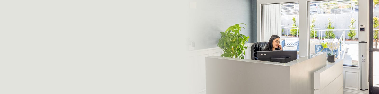 A lady sitting at the front desk answering the phone at Cypress Ridge