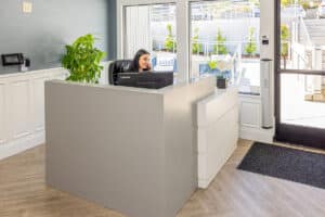 Woman answering the phone in the lobby at Cypress Ridge