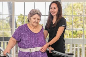 A nurse helping a patient walk at Cypress Ridge