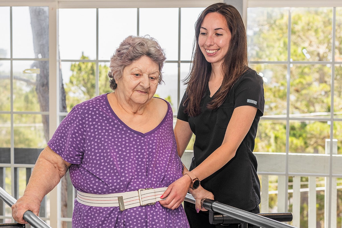 A nurse helping a patient walk at Cypress Ridge