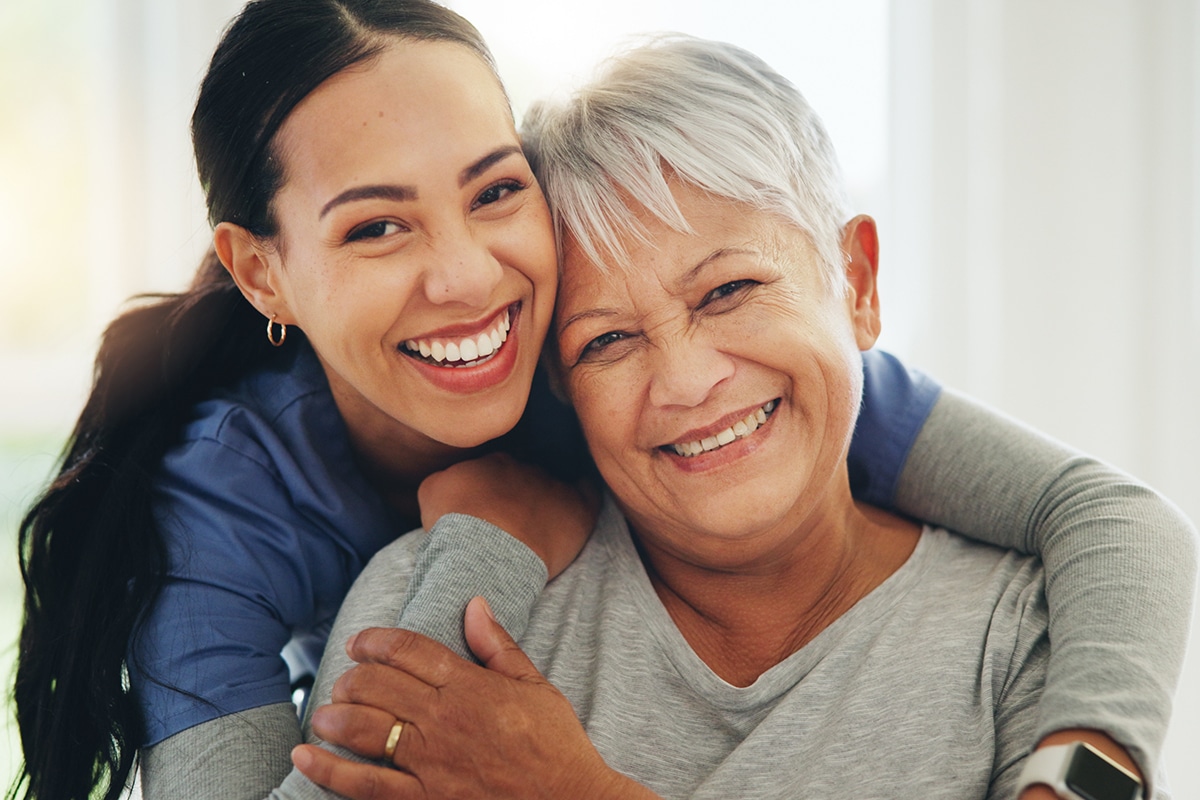 PACS-300x200-caregiver2 Happy nurse hugging senior patient