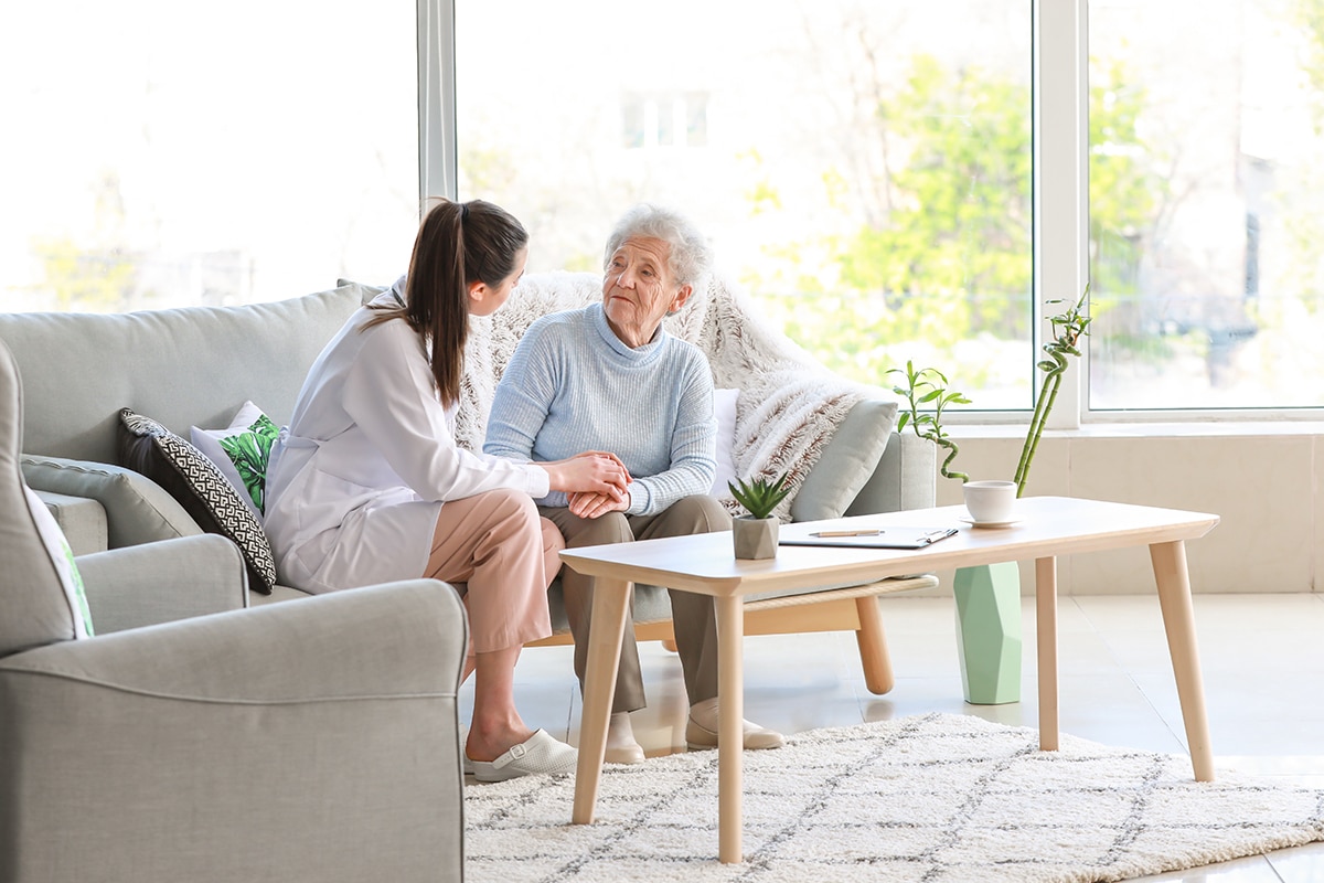 Doctor with senior woman in nursing home